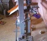 Toilet tissue rolling and cutting machine